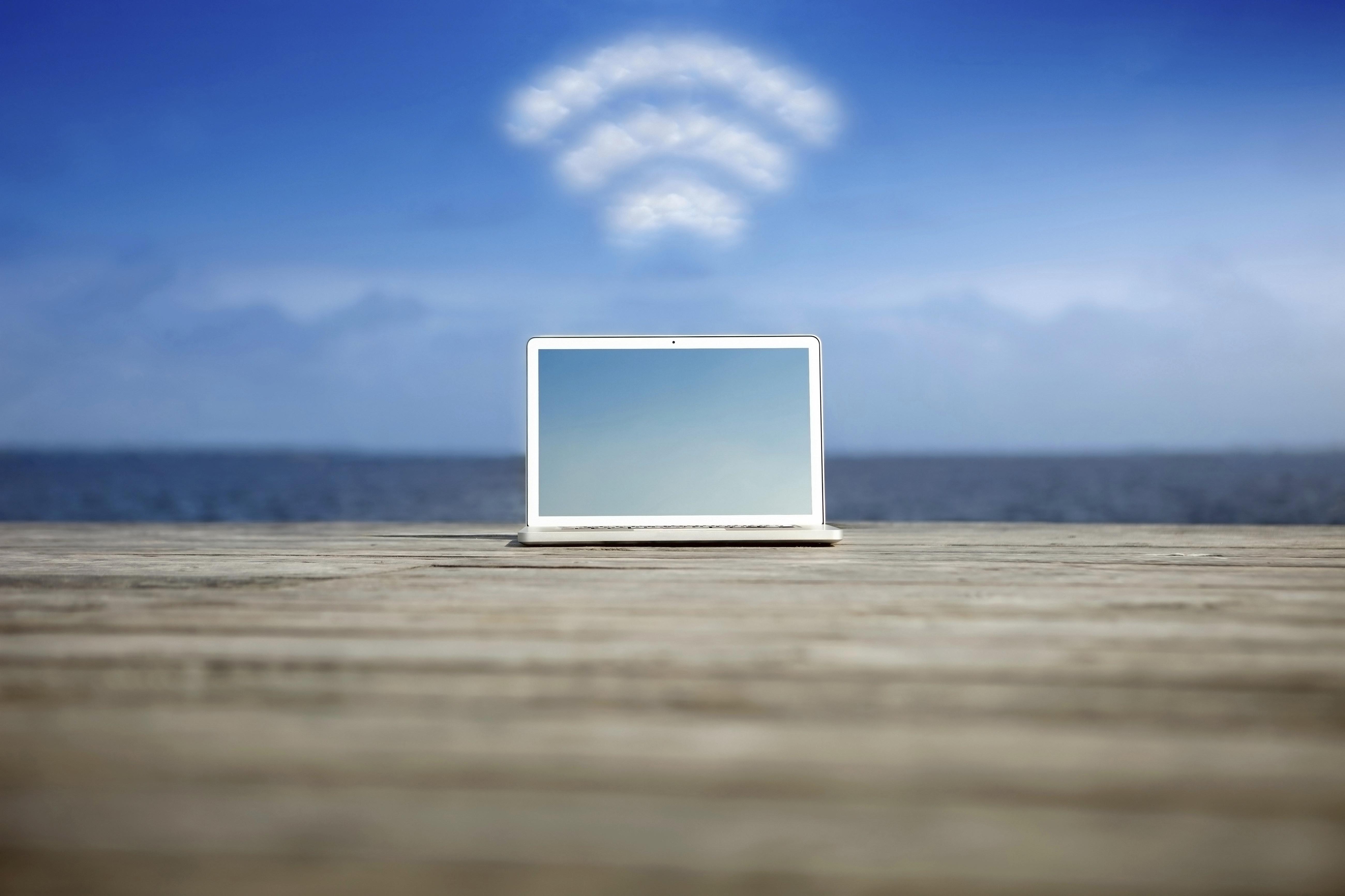 Laptop with wifi symbol at the coast