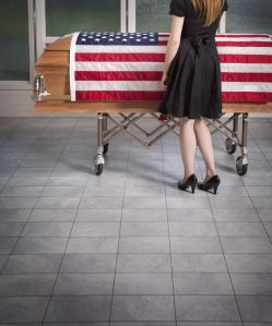Paying Respects To The Deceased With An American Flag Draped Over The Coffin