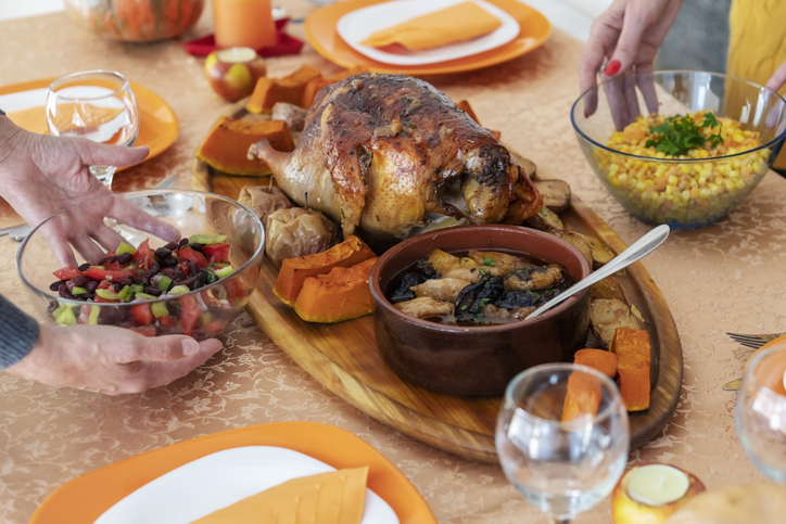 Female friends setting the table for Thanksgiving lunch