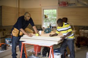 Father and son working in garage