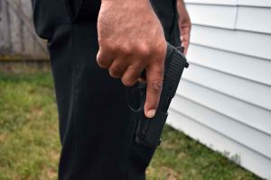 Police Officer holding handgun pistol