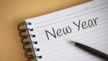 Close up of New Year Written on Notebook Corner
