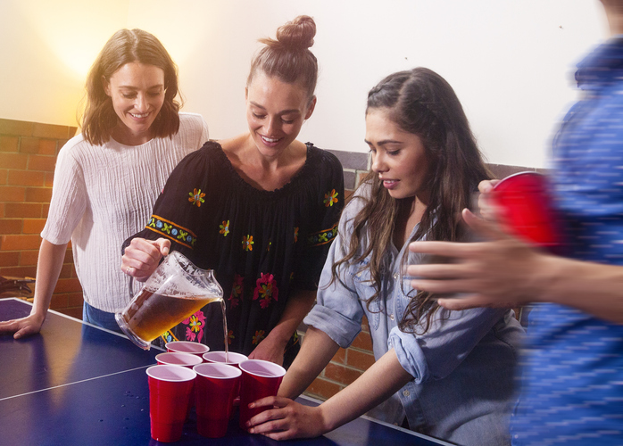 young adults Pouring drinks at a party