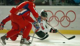 TURIN, ITALY. WEDNESDAY, FEBUARY 22, 2006. The Winter Olympics mens hockey quarterfinals are going on.Russia faced Canada at the Torino Esposizioni. In the first period Russian player #61 Maxim Afinogenov (hidden) takes down Canadian player #12 Jarome Igi
