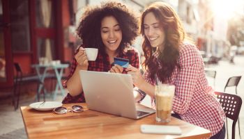 Girls drinking coffee and shopping online