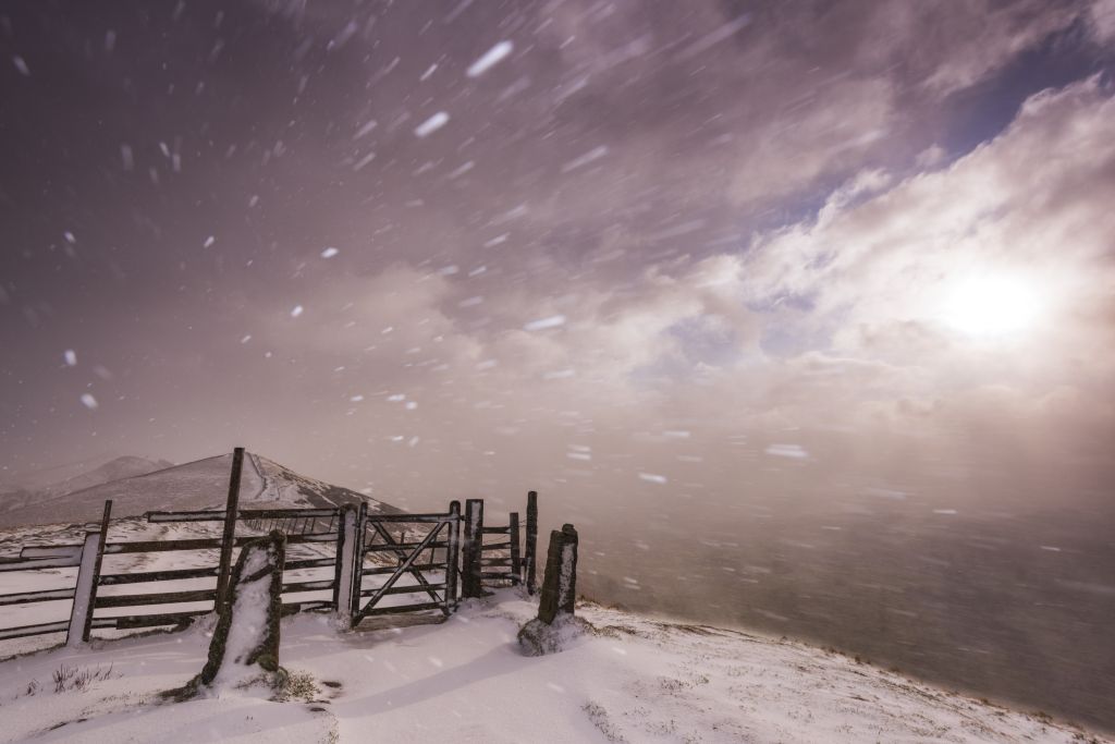 Severe blizzard conditions over Mam Tor at sunrise in the Peak District National Park, Derbyshire