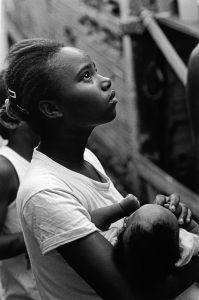 Brazil, Sao Paulo, Paraisopolis. A young mother holds her baby by her home in the favela Jardim Jaqueline in Sao Paulo, Brazil.