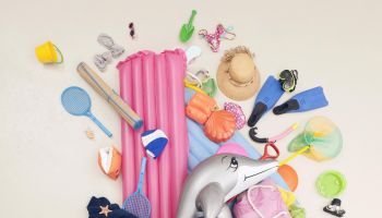 Germany, Artificial scene with children opening baggage full of beach toys