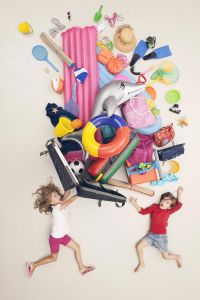 Germany, Artificial scene with children opening baggage full of beach toys