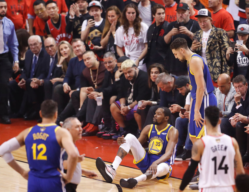 Golden State Warriors Kevin Durant sits on the floor after sustaining an injury to his right leg in the second quarter during game 5 of the NBA Finals between the Golden State Warriors and the Toronto Raptors at Scotiabank Arena on Monday, June 10, 2019