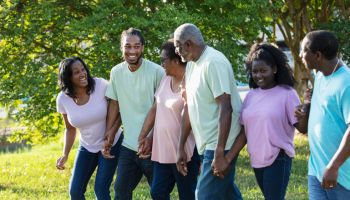 Multi-generation African-American family walk outdoors