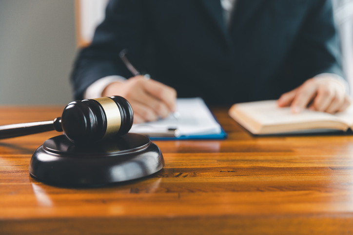 Justice and lawfirm concept. Female lawyer in office with brass scale. Woman hand gavel to bang. Law and justice trial session. Business lawyer notary stamping agreement, company secretary, validity.