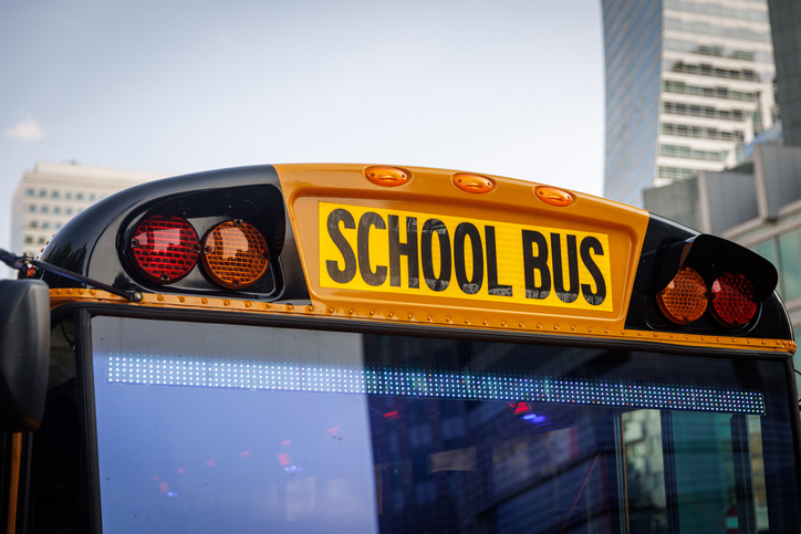 Yellow school bus in city street