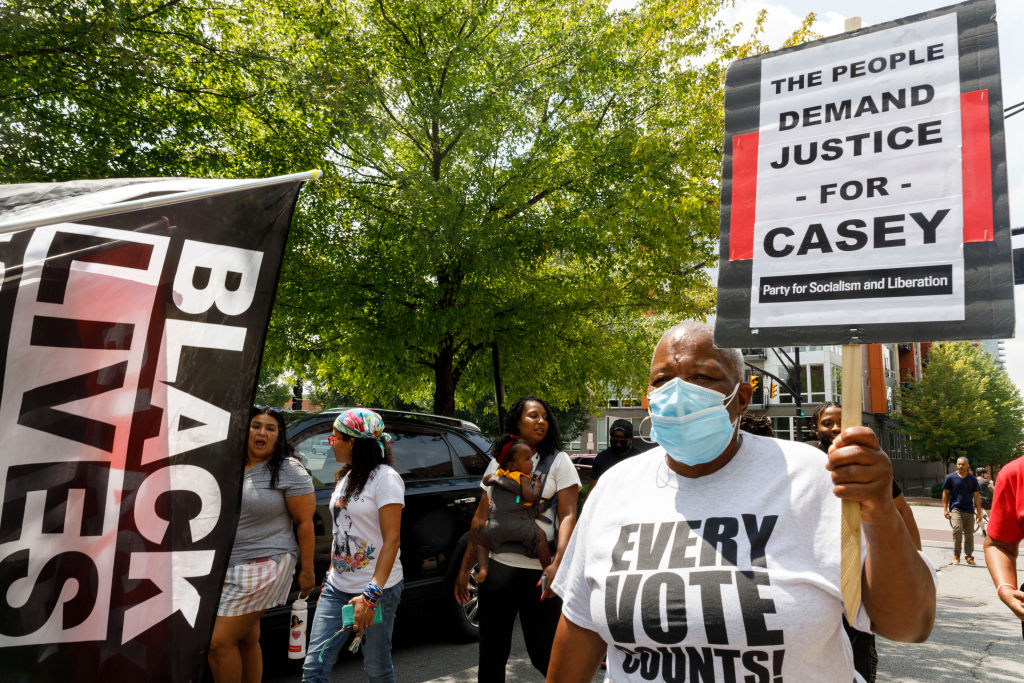 Debera Diggs, holds a placard advocating for Casey Goodson