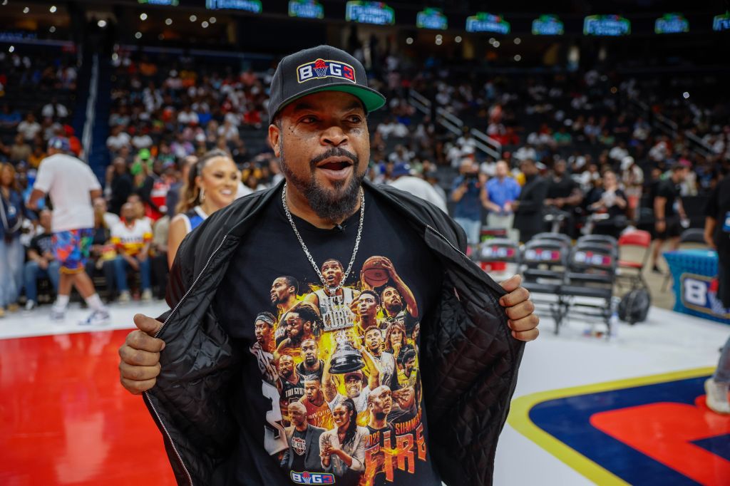 A man wearing a BIG3 hat and t-shirt celebrating during a basketball game at Capital One Arena.